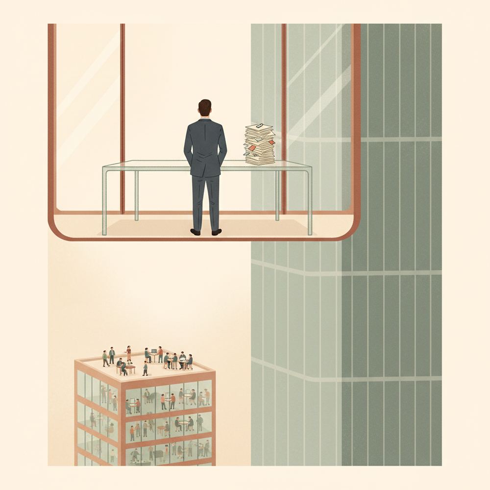 A solitary executive stands behind an empty desk in a glass office, looking out at a busy team in a separate building far below